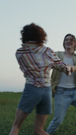 couple dancing in a field at sunset