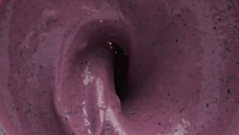 bananas falling milkshake blender bowl top view. milk berries smoothie preparing