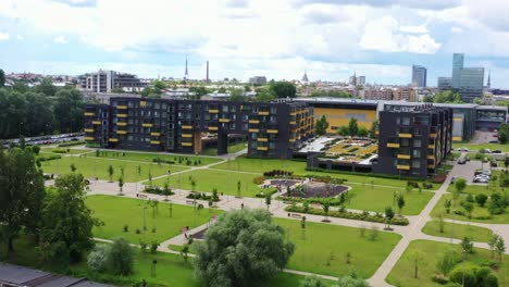 contemporary apartment buildings, green park in riga, latvia, sunny summer day