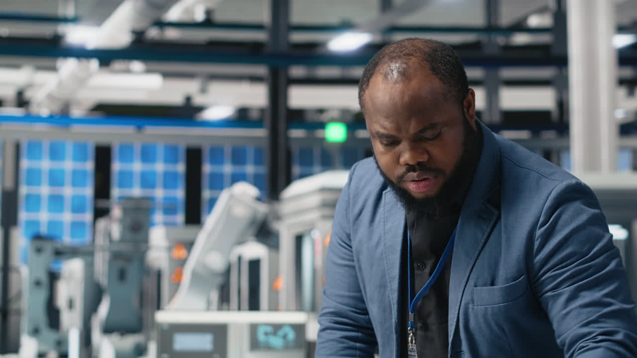Man working in a factory with automated machinery