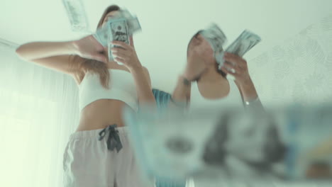 two women celebrating with money