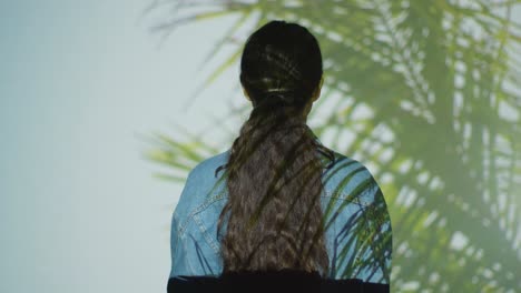 Woman-Visiting-Immersive-Art-Exhibition-Interacting-With-Images-Of-Palm-Leaves-Being-Projected-Onto-Her-Body-2