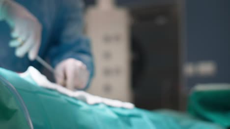 Surgeon-using-medical-scissors-during-an-operation