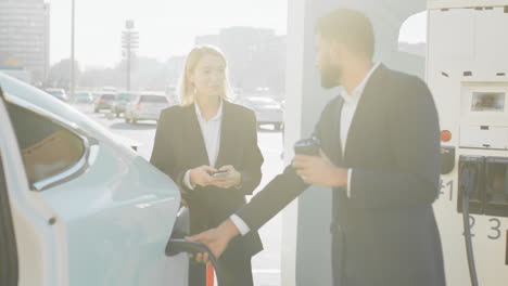 business people charging electric vehicle