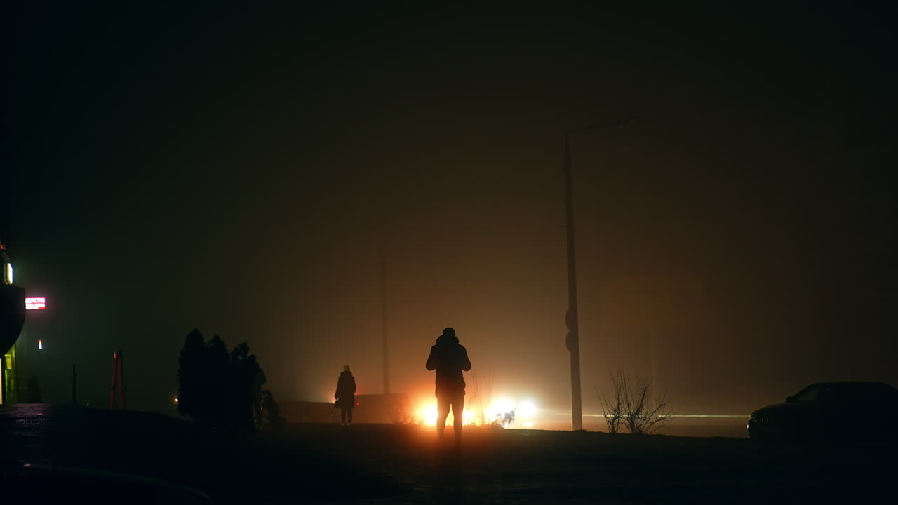 People Walking in Foggy Night