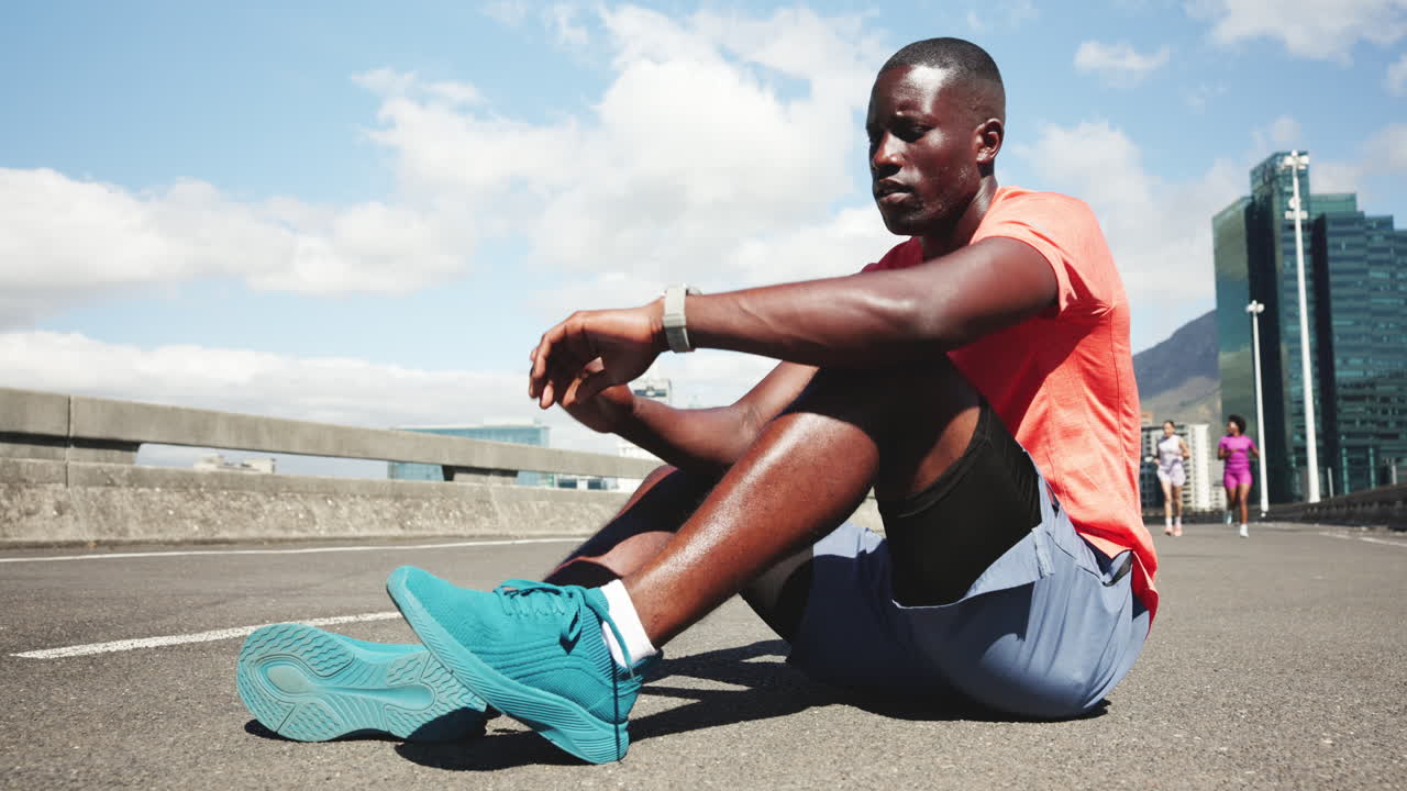 Black Man Tying Shoelaces on Road Before a Run in the City