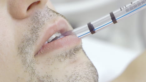 man undergoing a medical procedure with a tube in his mouth