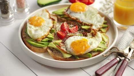 delicious healthy breakfast with sliced avocado sandwiches with fried egg