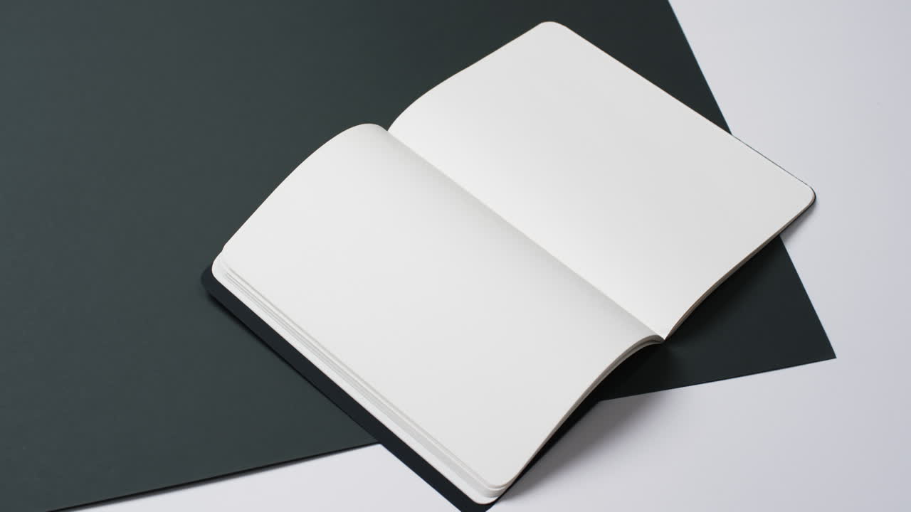 Video of book with white blank pages and copy space on black and white background