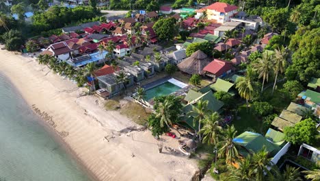 An-aerial-shot-of-few-coconut-trees-over-tropical-lagoon-with-white-sand-in-Koh-Pangan,-Haad-Rin,-Thailand