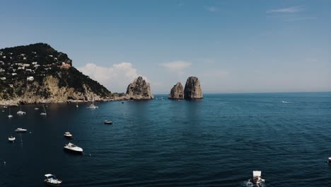 aerial of capri, italy's beautiful sea water filled with boats