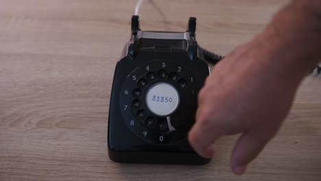 dialing a phone number on an antique rotary dial phone