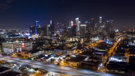 drone hyperlapse of the south side of downtown los angeles skyline at night