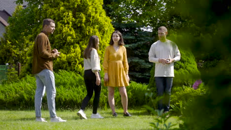 distant view of caucasian young woman throwing a petanque ball in the park on a sunny day