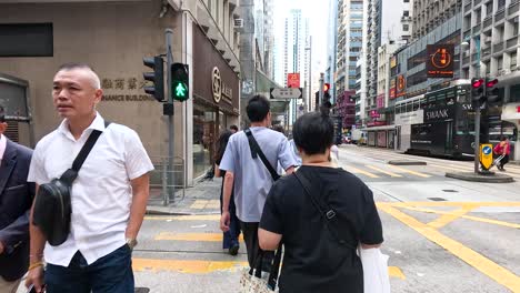 people walking and crossing at a city intersection