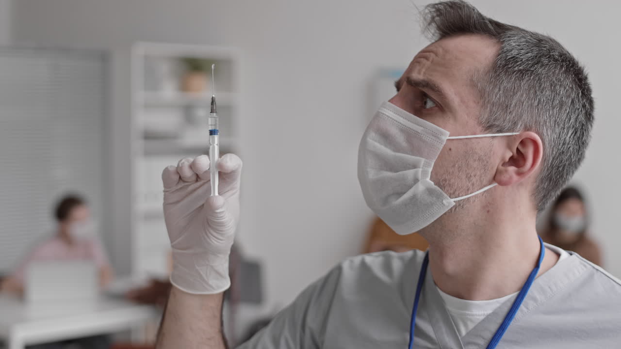 Doctor Holding Syringe and Posing