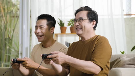 senior and young asian men in the living room