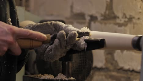 woodworker planing a table leg with precision