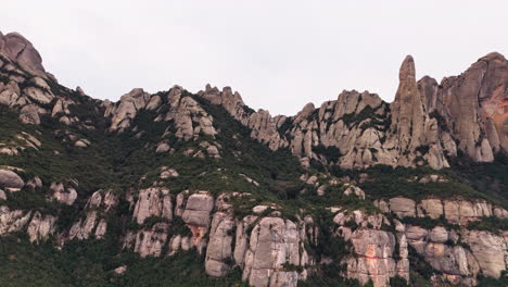 drone fly by of great green cliff peaks on tranquil overcast day