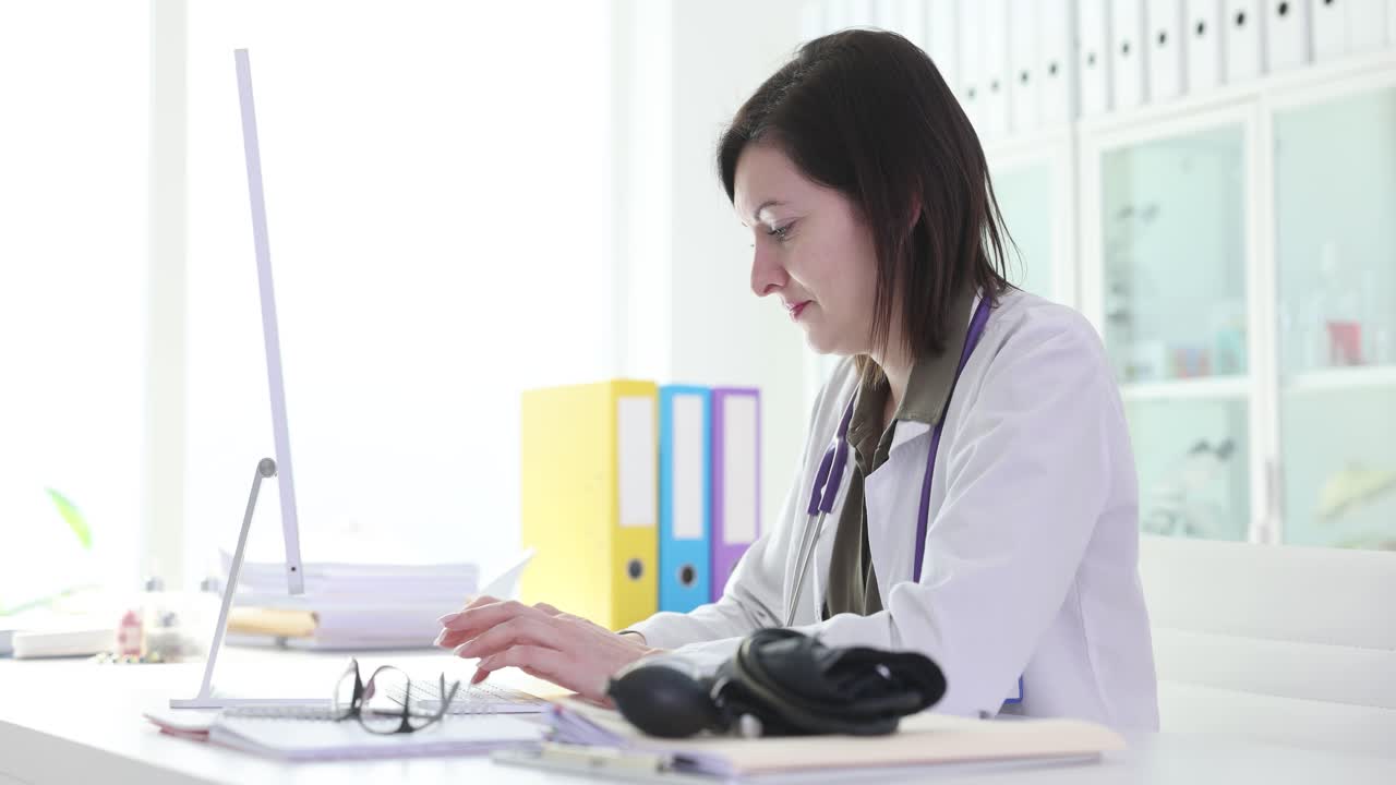 Female Doctor Working on Computer in Medical Office