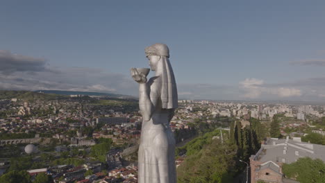 drone shot of mother of georgia statue in tbilisi tourist attraction