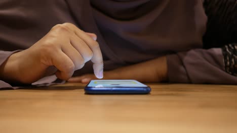 woman using a smartphone in a cafe