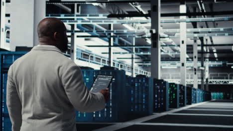 vertical video programmers walking in data center coding, doing optimizations using tablet