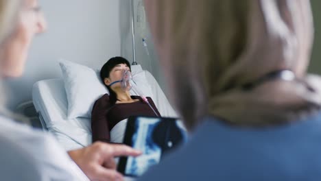 female doctors discussing x-ray 4k