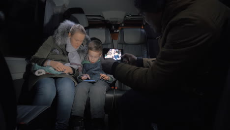 minibus travel taking mobile video of mom and kid playing on cellphone