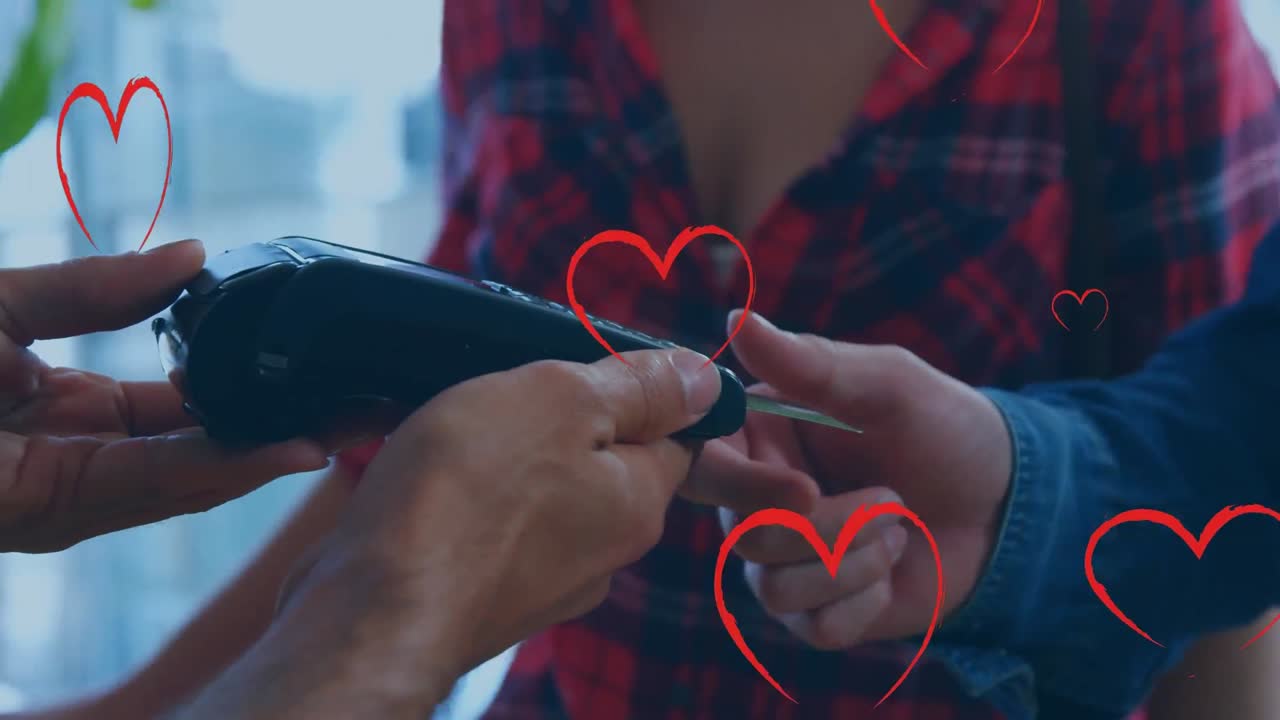 결제 터미널을 사용하는 사람들 위에 떨어지는 심장의 애니메이션