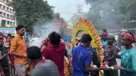 group of men unloading durga idol from truck on last day of durga puja (vijay dasahmi) in kolkata, india.