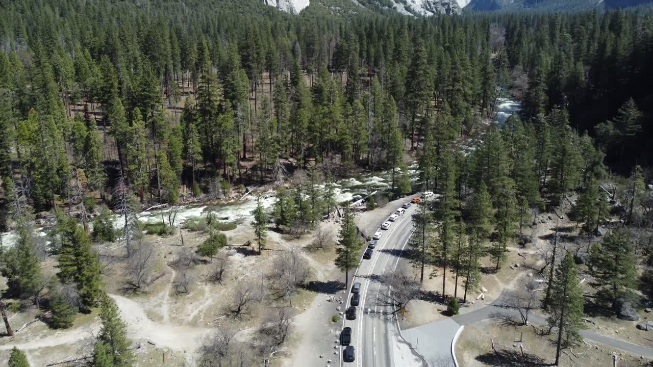 Fresh Spring Snowmelt Rushing Down The Scenic Wilderness Of Yosemite National Park, California, USA. Cars And Bikes Lined Up In The Heart Of Yosemite Valley.