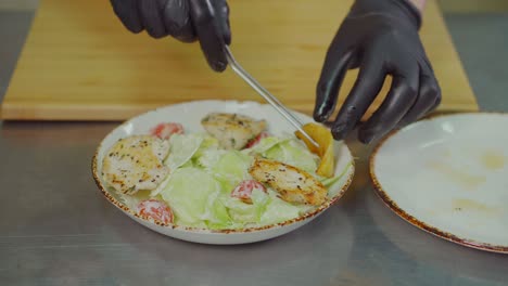 chef preparing a caesar salad