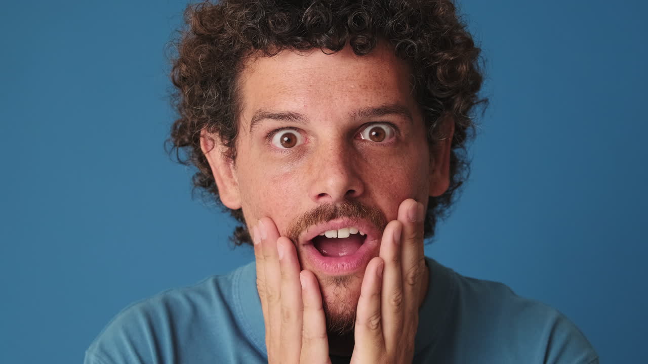 Surprised Man with Hands on Face