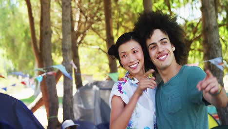 Couple-embraching-and-pointing-at-distant-in-park-4k