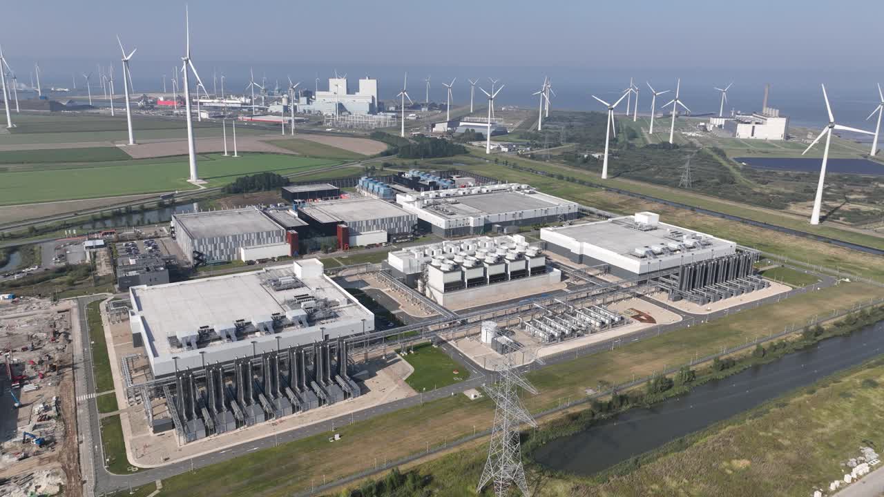 Aerial View of a Large Data Center Near Wind Turbines