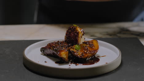 Slow-motion-shot-of-a-chef-plating-a-gourmet-sweet-potato-dish-in-a-restaurant