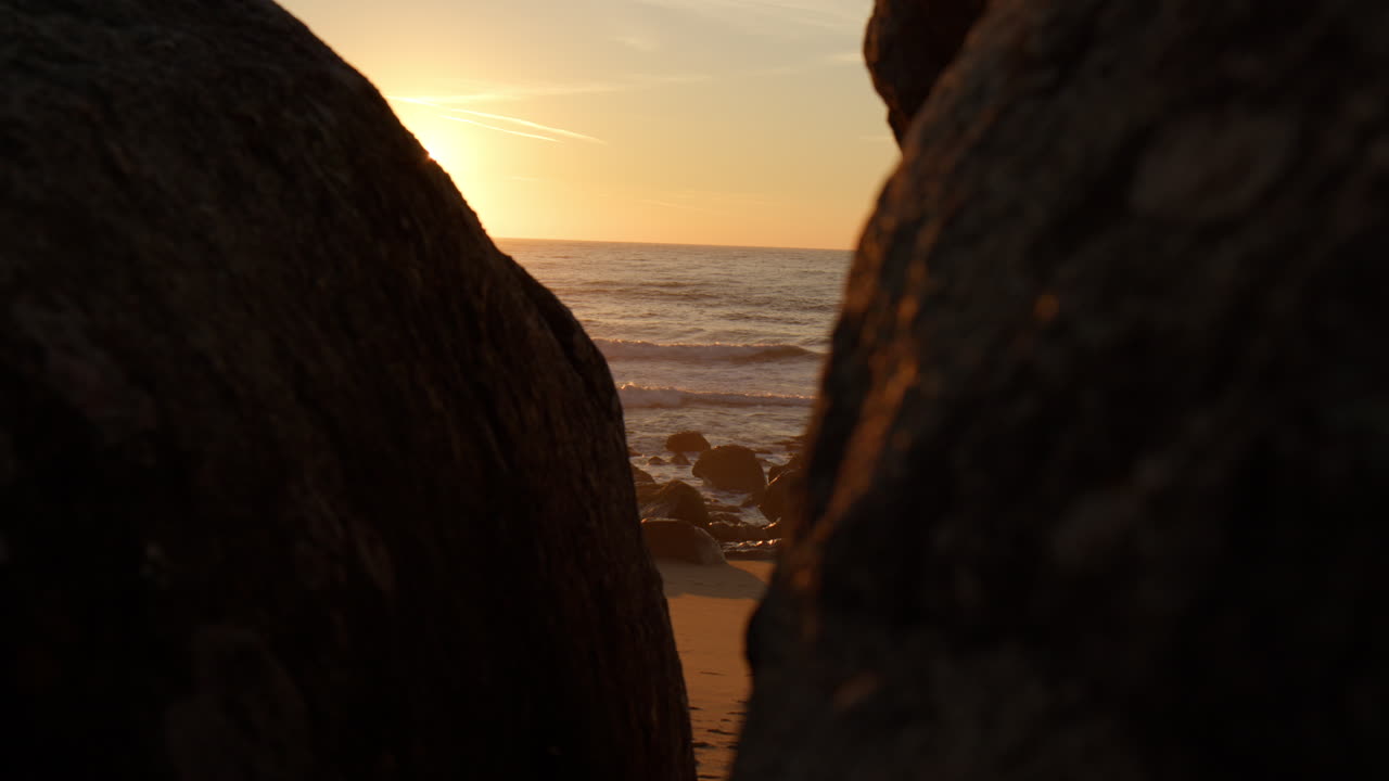 Sunset Beach Behind Rock Boulders In Vila Nova de Gaia, Portugal. Slow Motion Shot