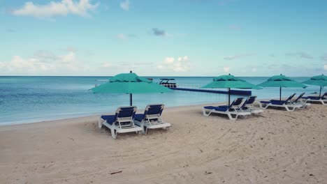 orbit shot of beach chairs and umbrellas during a bright morning