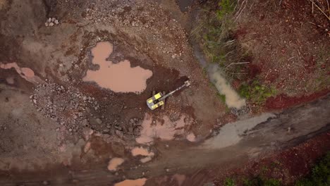 overhead shot of excavator removing rock in open stone quarry, brazil