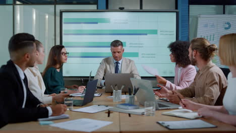 multiethnic business team clapping hands in office