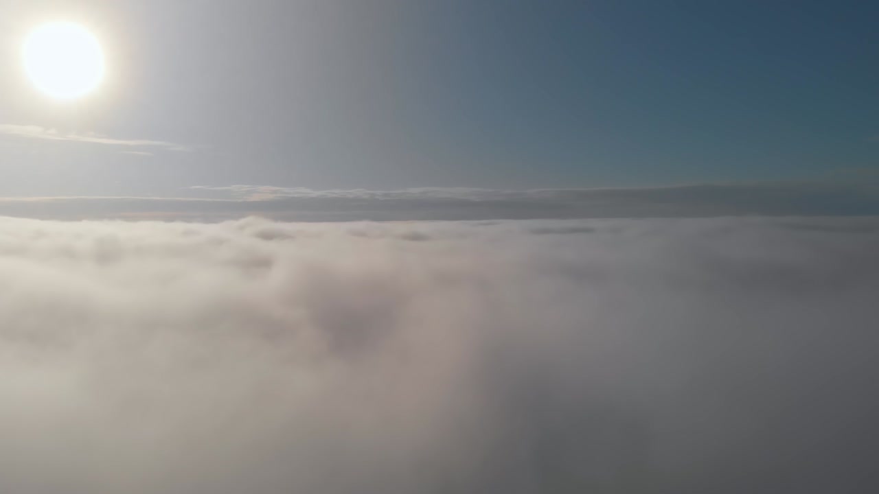 vuelo por encima de las nubes al sol. vuelo suave por encima de nubes esponjosas, cielo azul y sol brillante por sobre las nubes, la tierra no es visible bajo las nubes. vida celestial en el paraíso alto