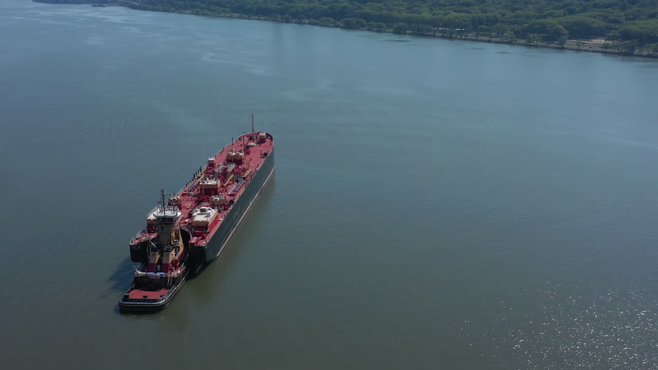 una vista de drones de una gran barcaza roja en el río hudson en ny en un día soleado