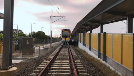 City-bound-commuter-train-ready-to-depart-train-station-with-guard