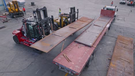 aerial view of freight elevator loading steel on industrial truck at port of haina,dominican republic