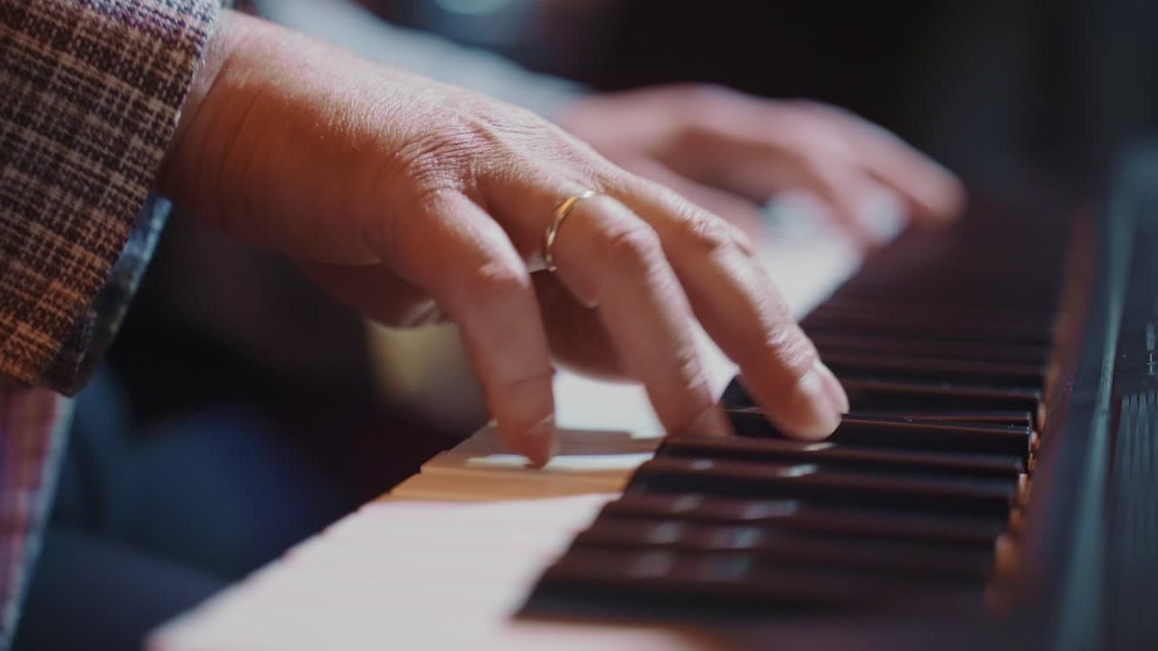 Close Up of Musician's Hands Playing Piano Keys