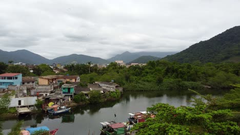 Aerial-flying-over-coastal-district-of-Ubatuba-on-cloudy-day,-Brazil