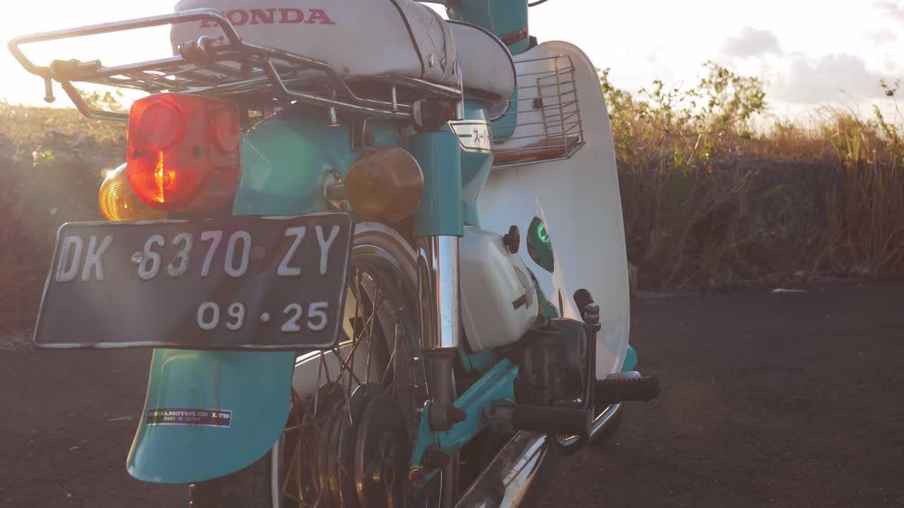 Rear view of a vintage Honda motorcycle at sunset