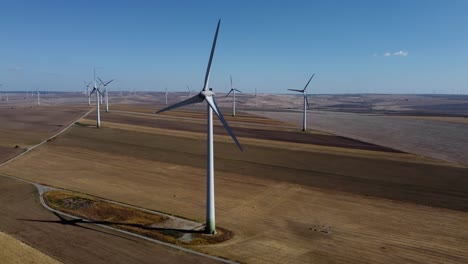 Drone-flying-amongst-wind-turbines-on-wind-farm,-Europe