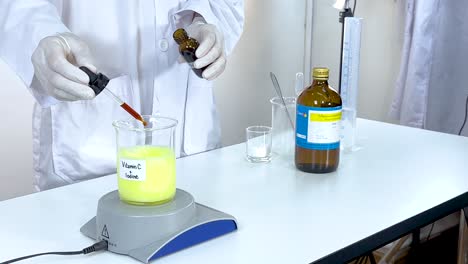 a scientist conducts an iodine clock reaction using vitamin c and starch in a lab setting with controlled lighting